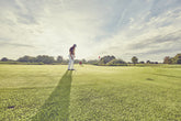 A golfer enjoying a high-performance round on a premium golf course with smooth fairways and scenic views.